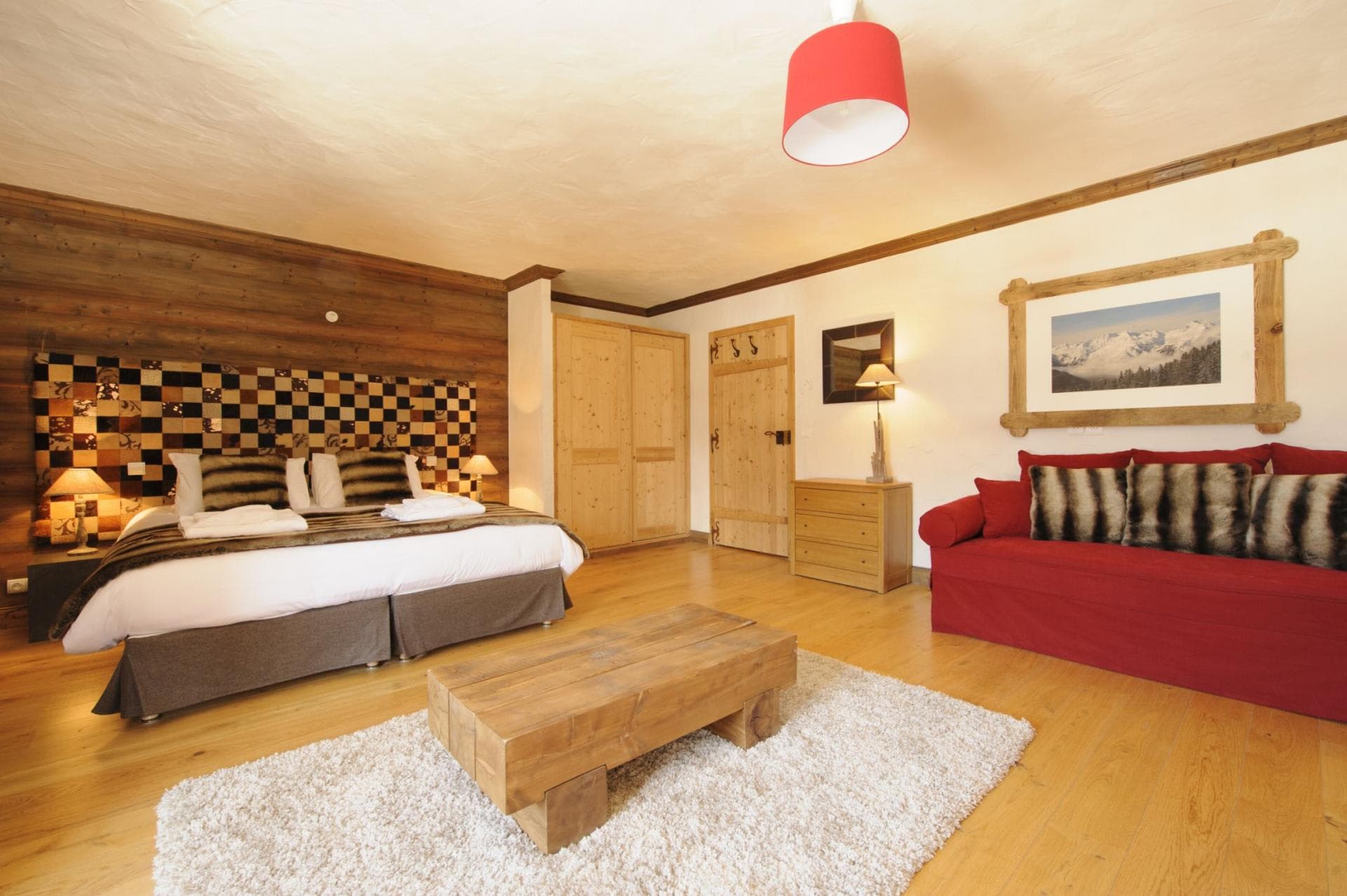 Guest suite with king bed, sofa, and built-in closet storage