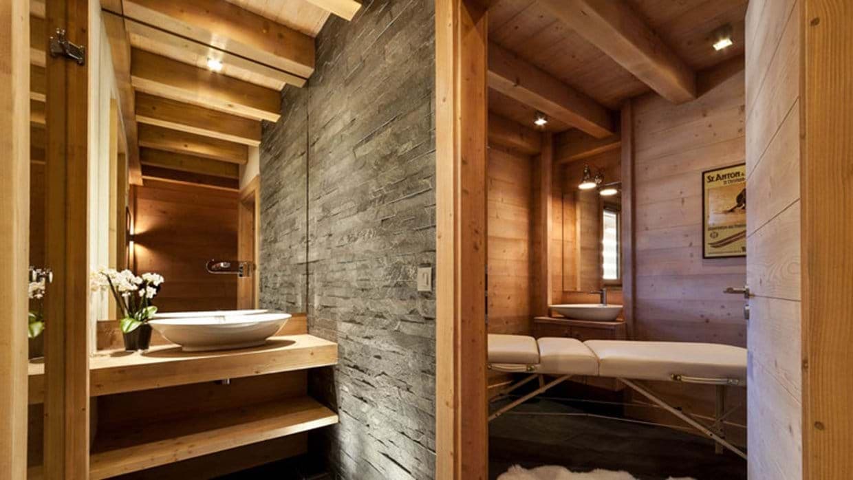 Spa room with massage table and dual vanity areas