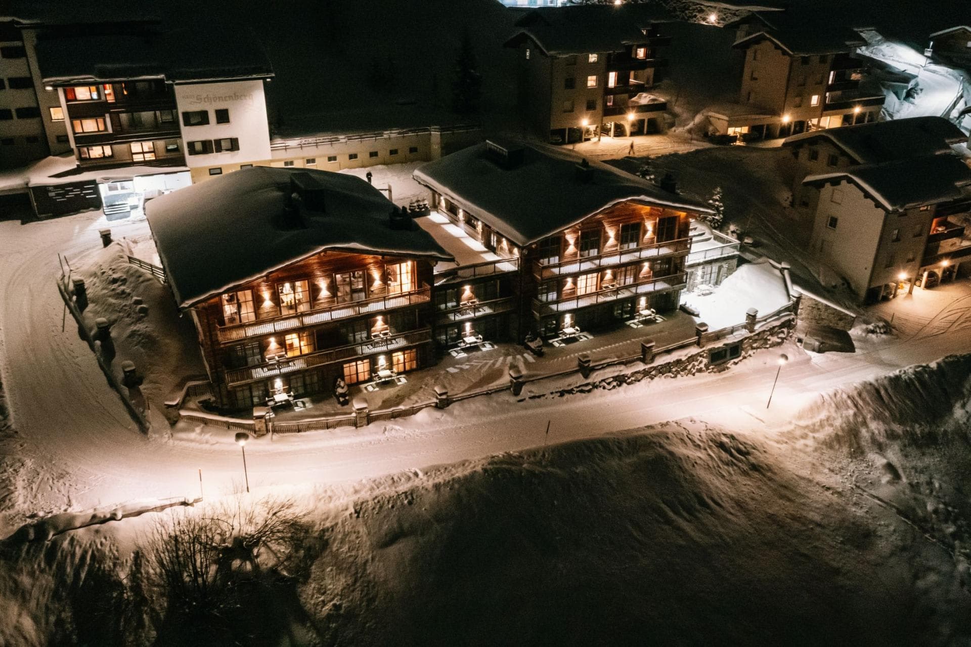 Aerial night view of chalet showing private balconies and ground-level patio access