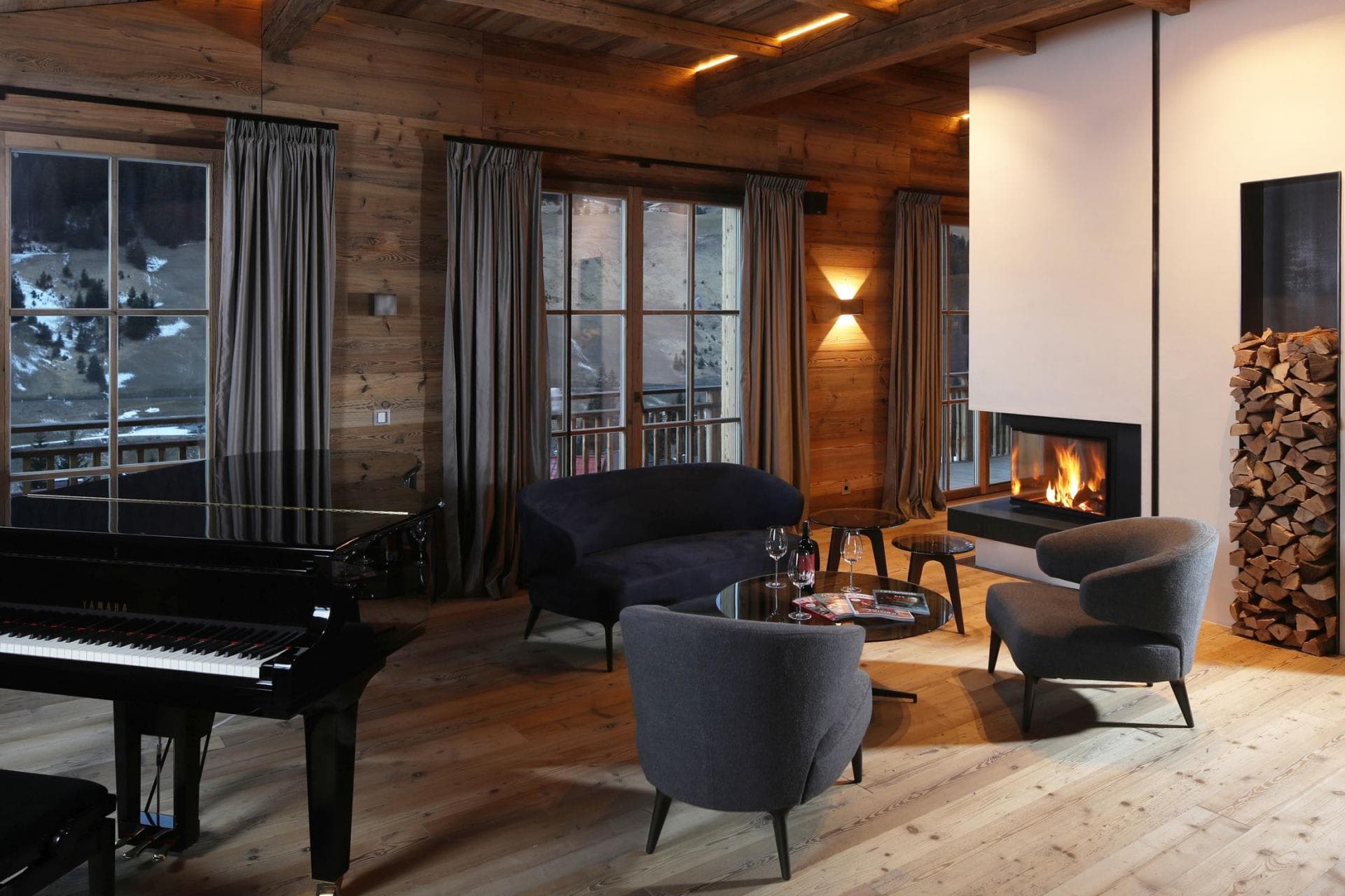 Living area with wood-burning fireplace and Yamaha baby grand piano