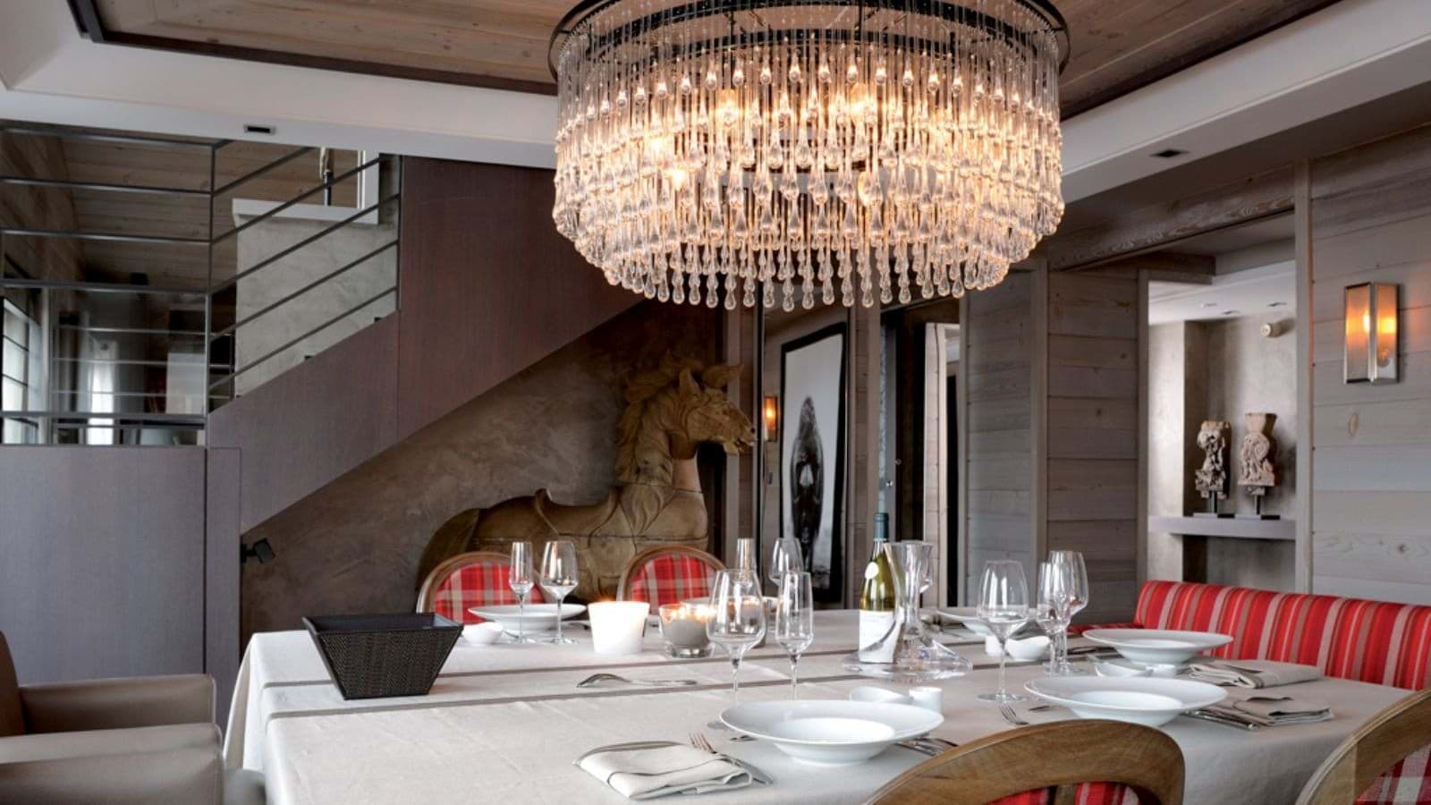Dining area with banquette seating and tiered crystal chandelier