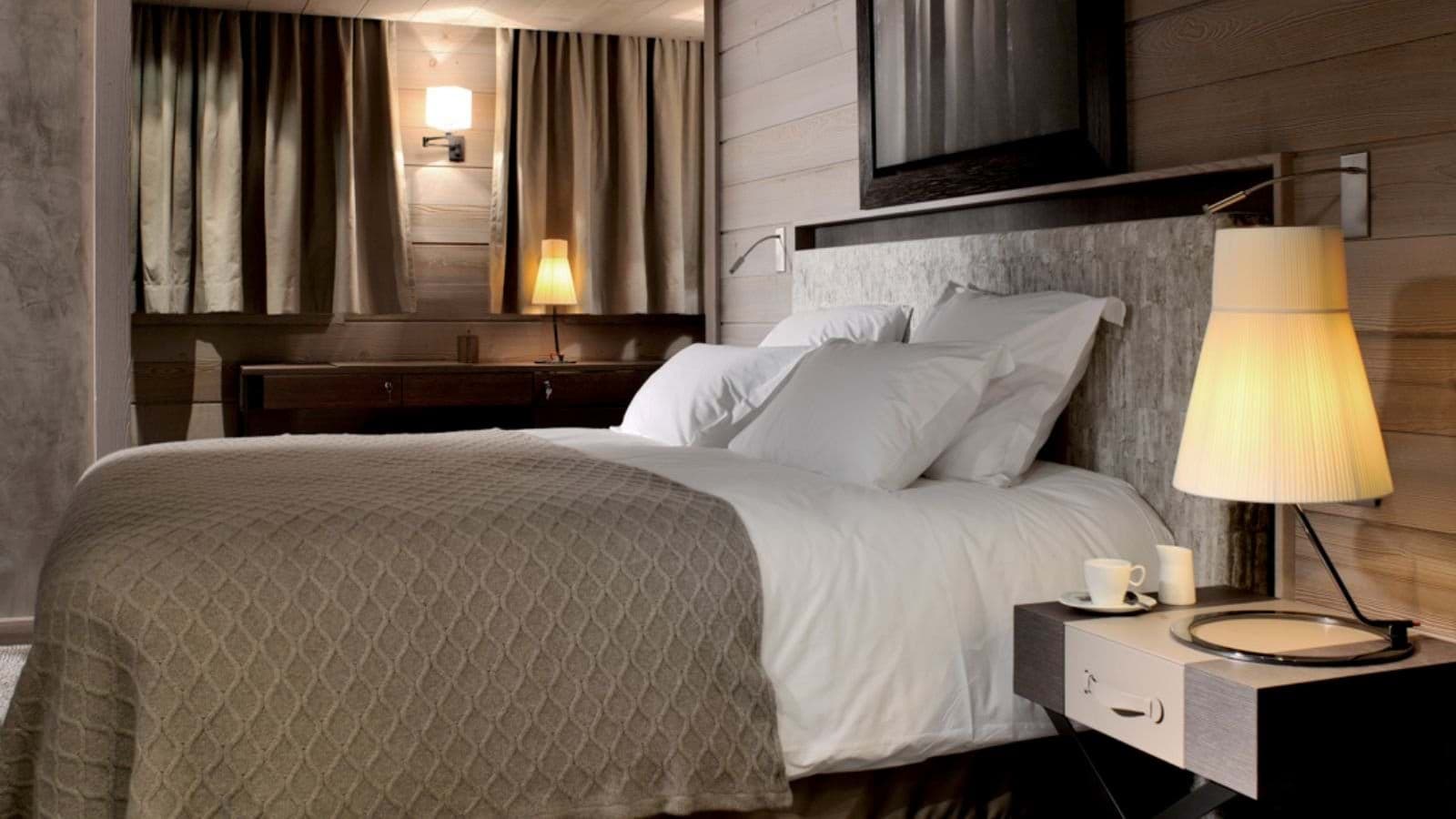 Guest bedroom with queen bed and integrated reading lights