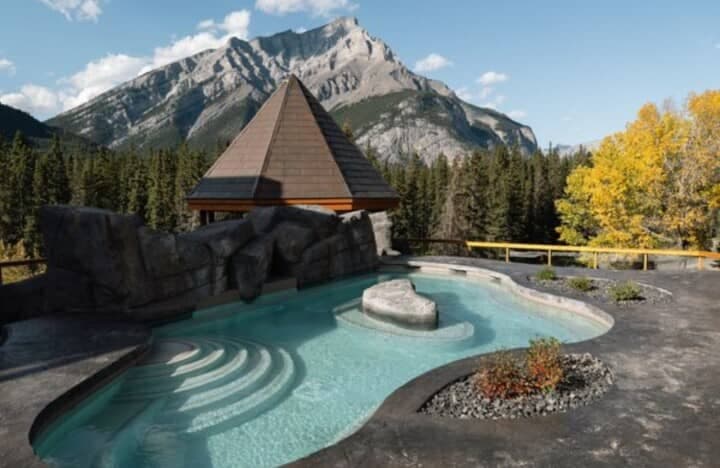 Outdoor heated pool with rock features and mountain views