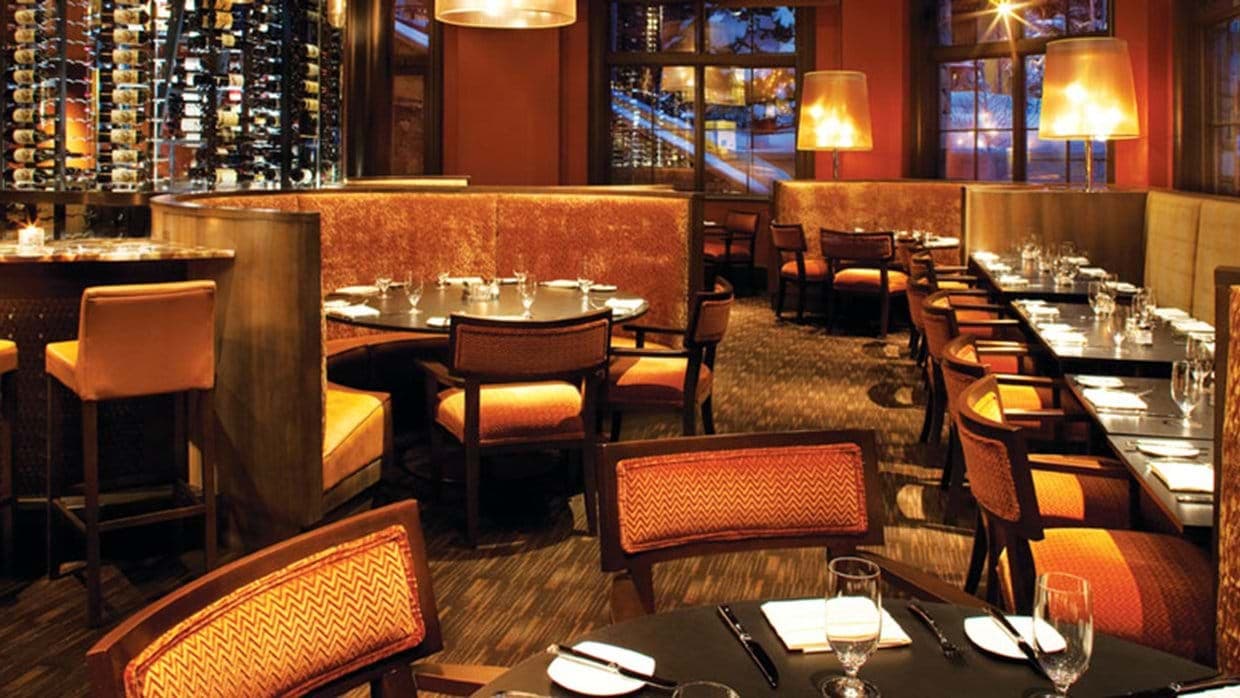 Dining area with booth seating and temperature-controlled wine wall