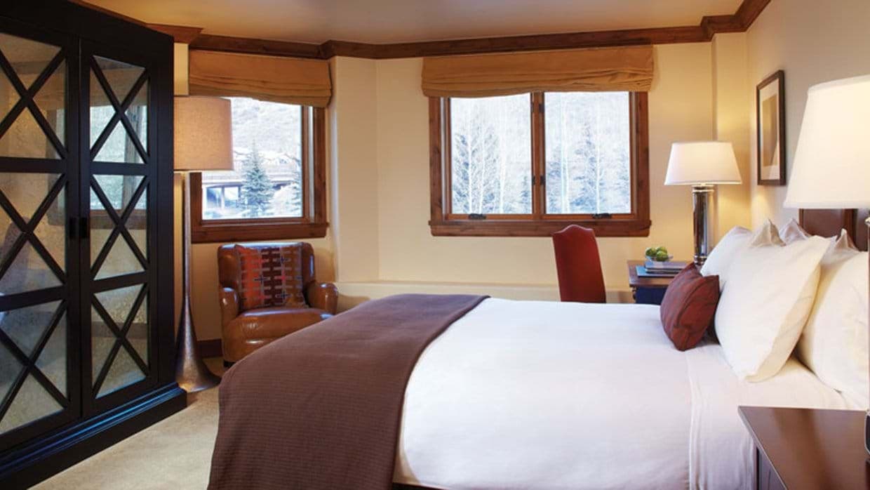 Guest bedroom with king bed, mirrored wardrobe, and workstation