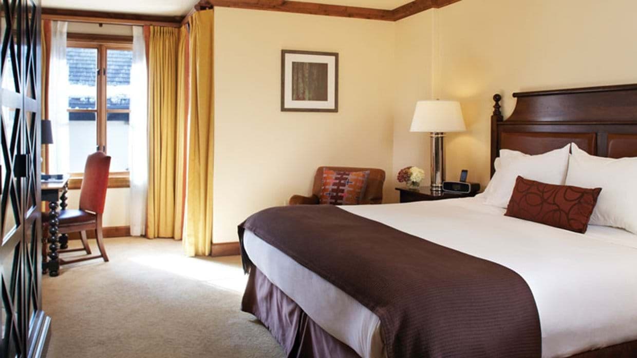 Guest bedroom with king bed and window-side desk station