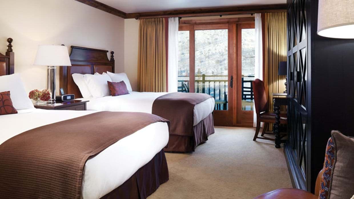 Guest bedroom with two queen beds and private balcony access