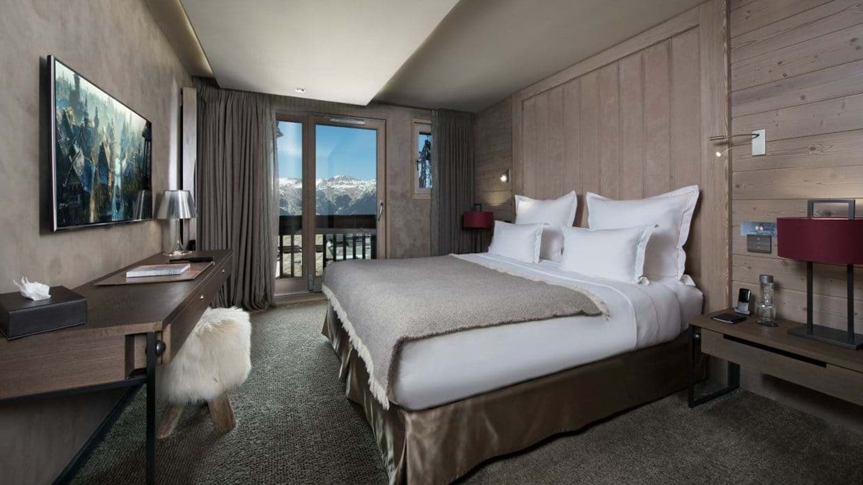 Bedroom with king bed and balcony access; mountain views