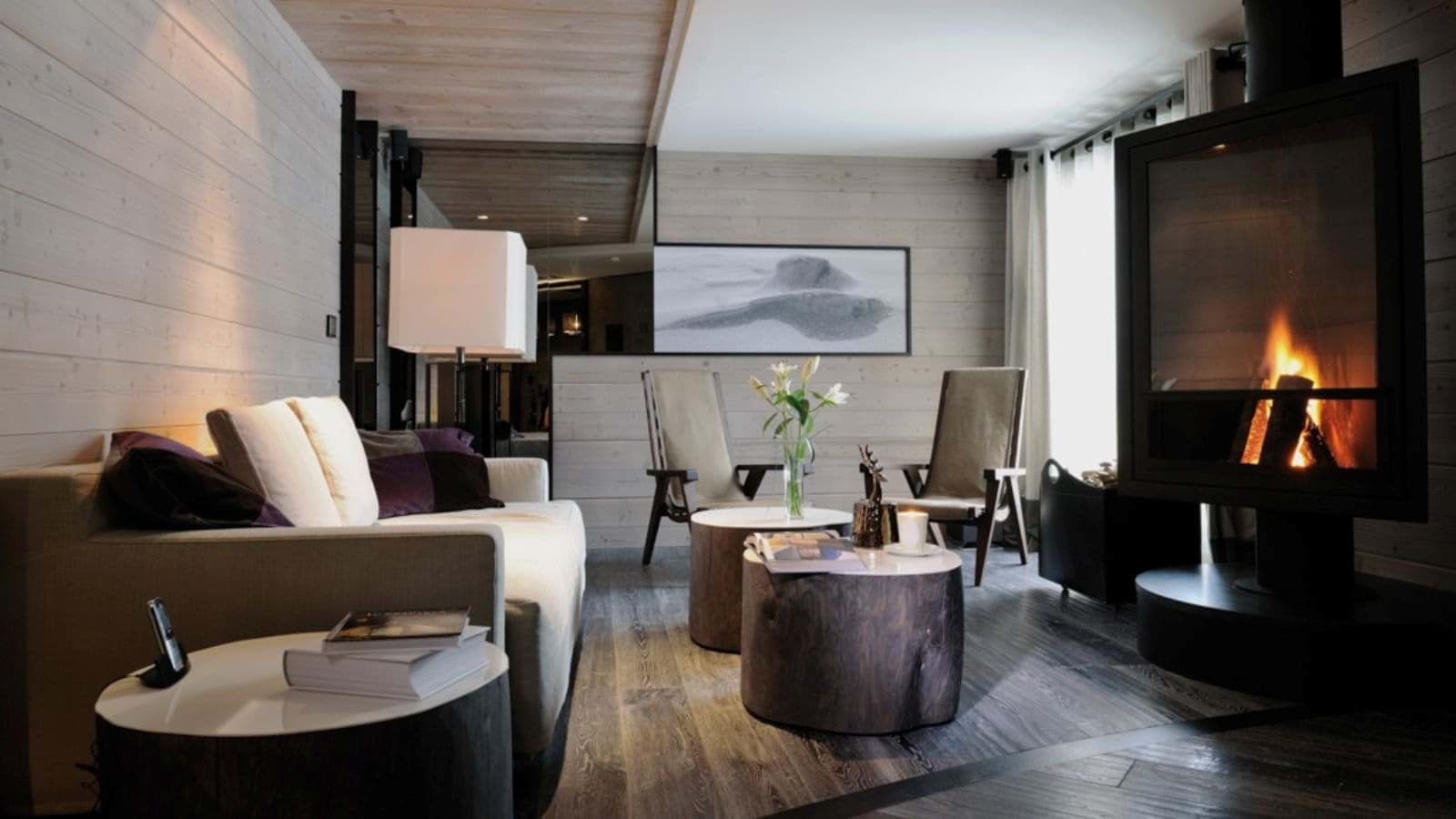 Living area with glass-front wood stove and seating for five