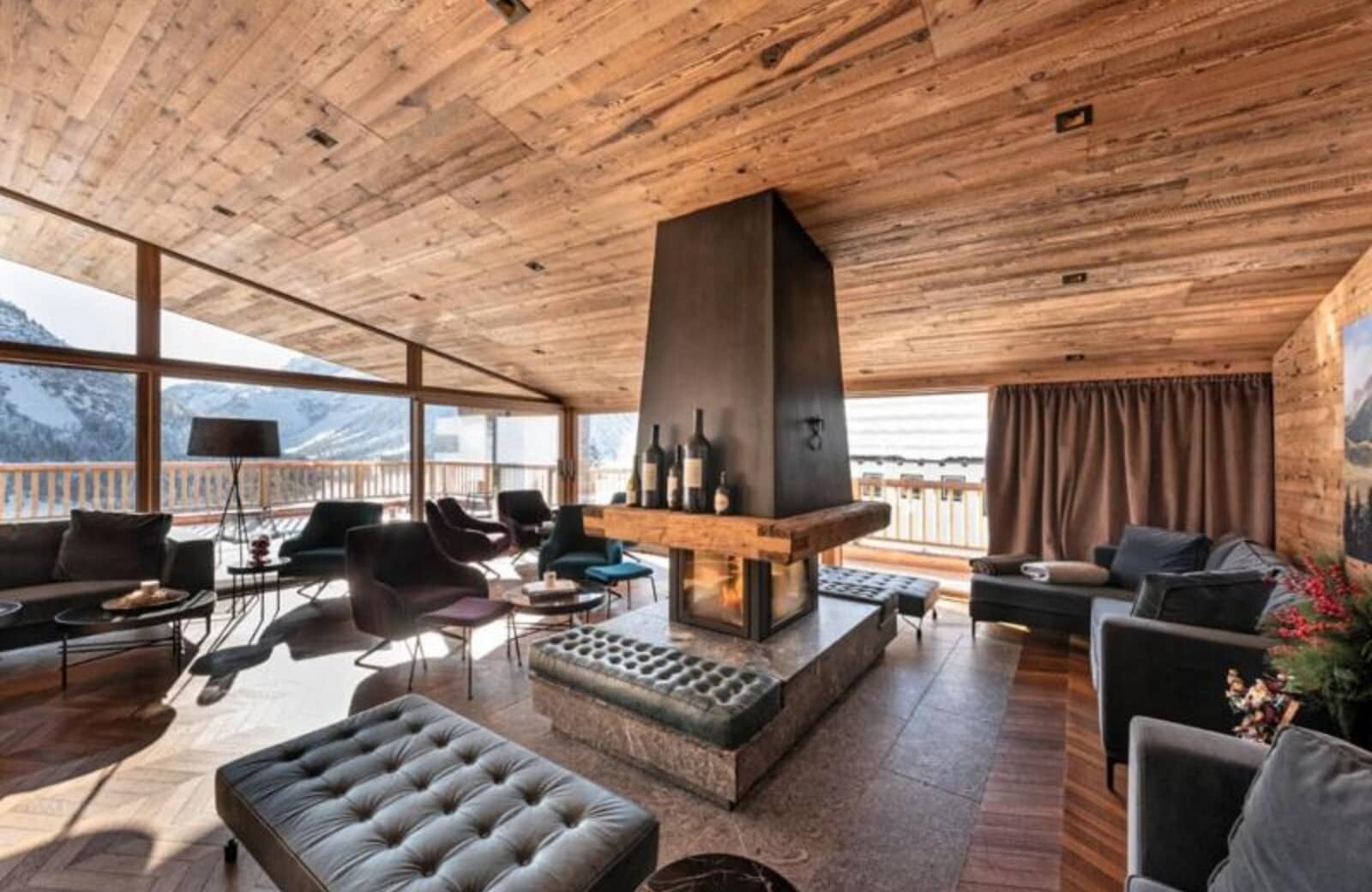 Lounge area with 360-degree fireplace and mountain views