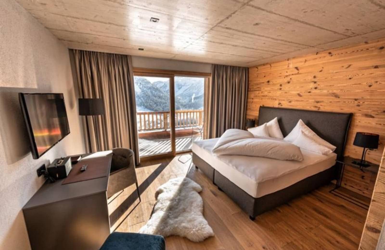 Primary bedroom with king bed and private balcony mountain views