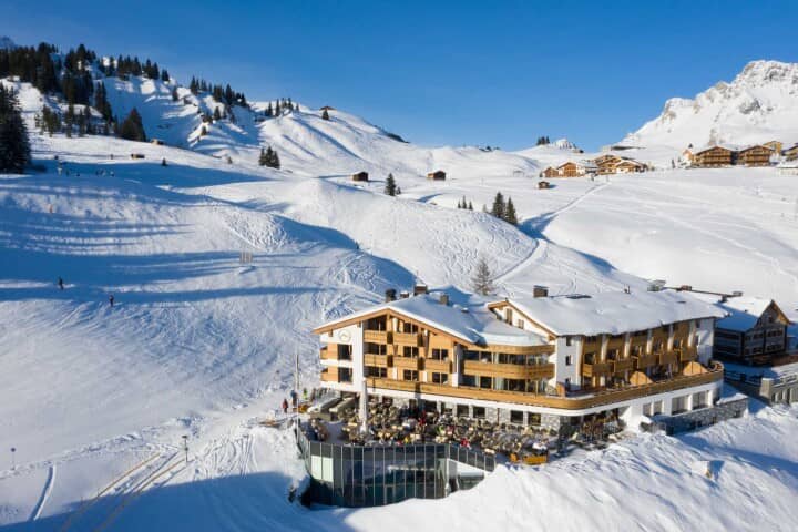 Ski-in/ski-out lodge with outdoor dining terrace and mountain-view balconies