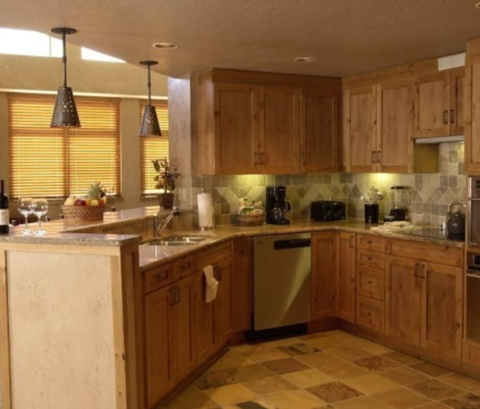 Kitchen with wood cabinetry and granite breakfast bar