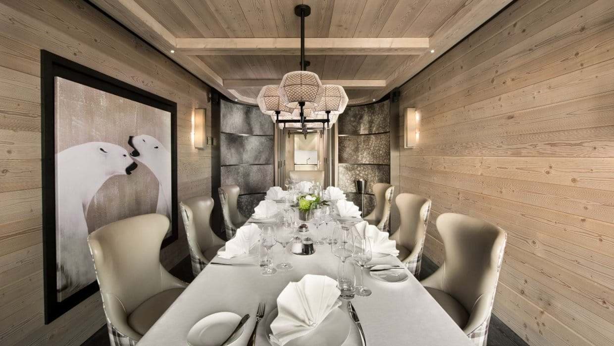 Dining room with wood-paneled walls and seating for 8