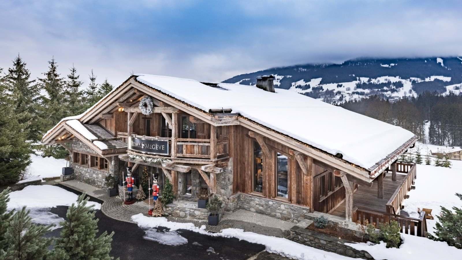 Chalet exterior with stone and timber construction and mountain views