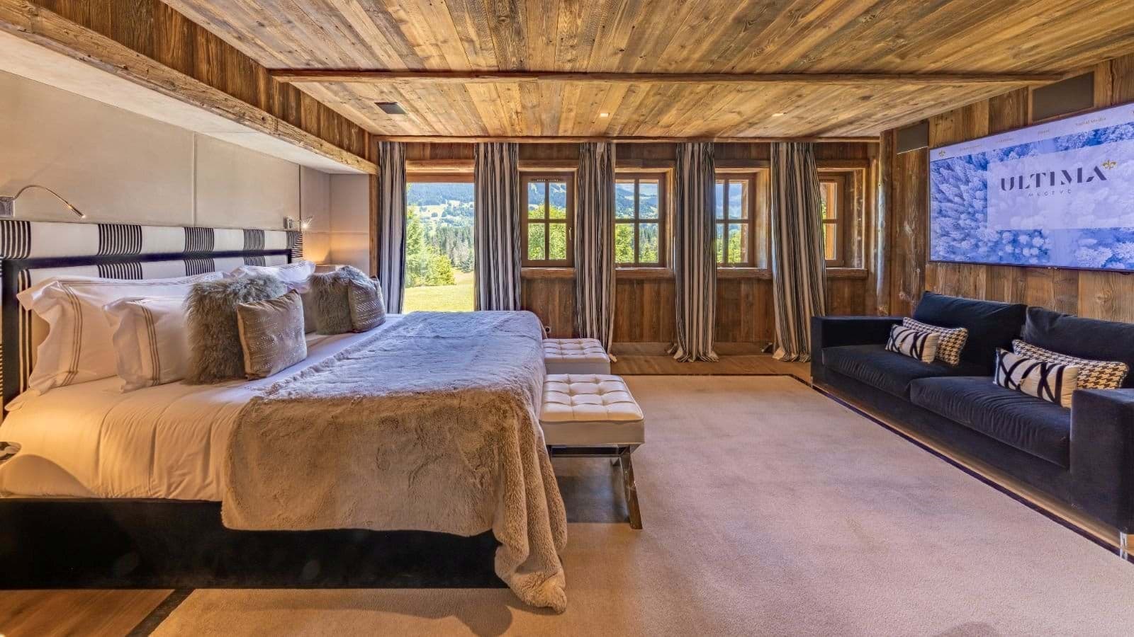 Primary bedroom with king bed, wood-paneled ceiling, and valley views
