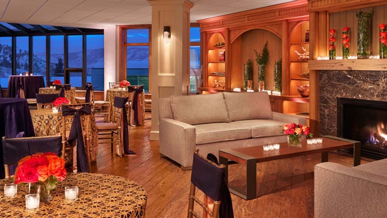 Shared lounge with gas fireplace, sofa seating, and mountain views