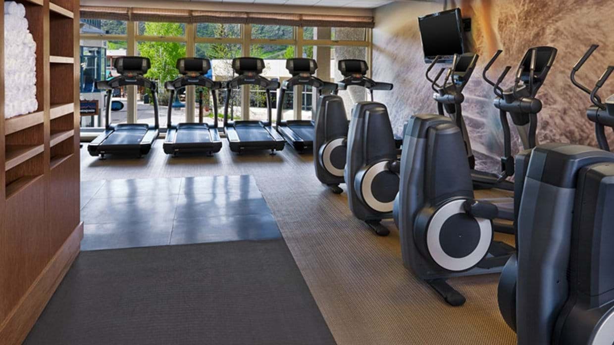 Fitness center with Precor treadmills and ellipticals overlooking the village
