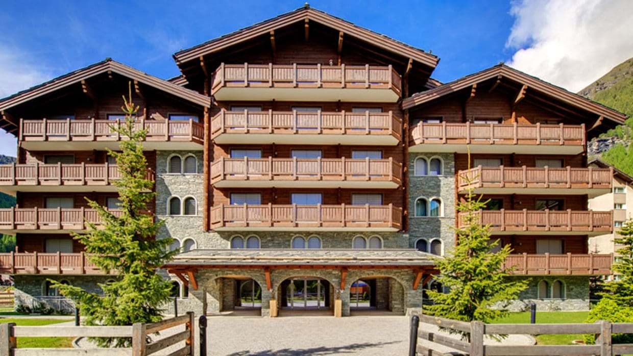 Stone and timber chalet exterior with private balconies for every unit