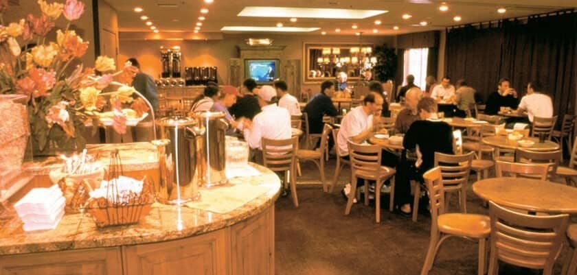 Shared breakfast area with coffee station and ample table seating