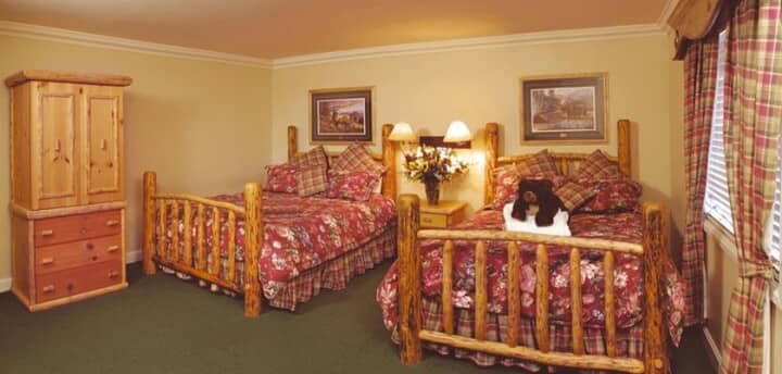 Guest bedroom with two queen beds and log-style frames