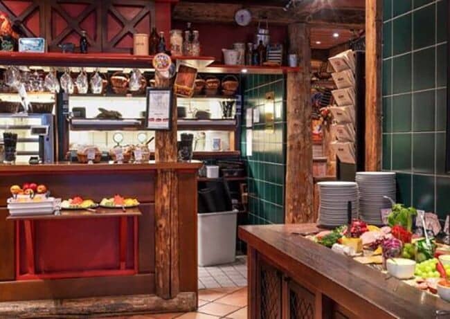 Buffet area with breakfast station and rustic timber beam accents