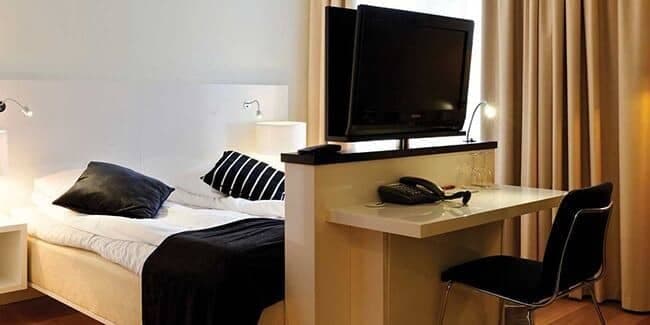 Guest suite with workspace and swiveling television for bedside viewing