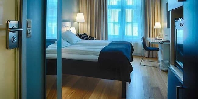 Guest bedroom with two twin beds and dedicated workspace