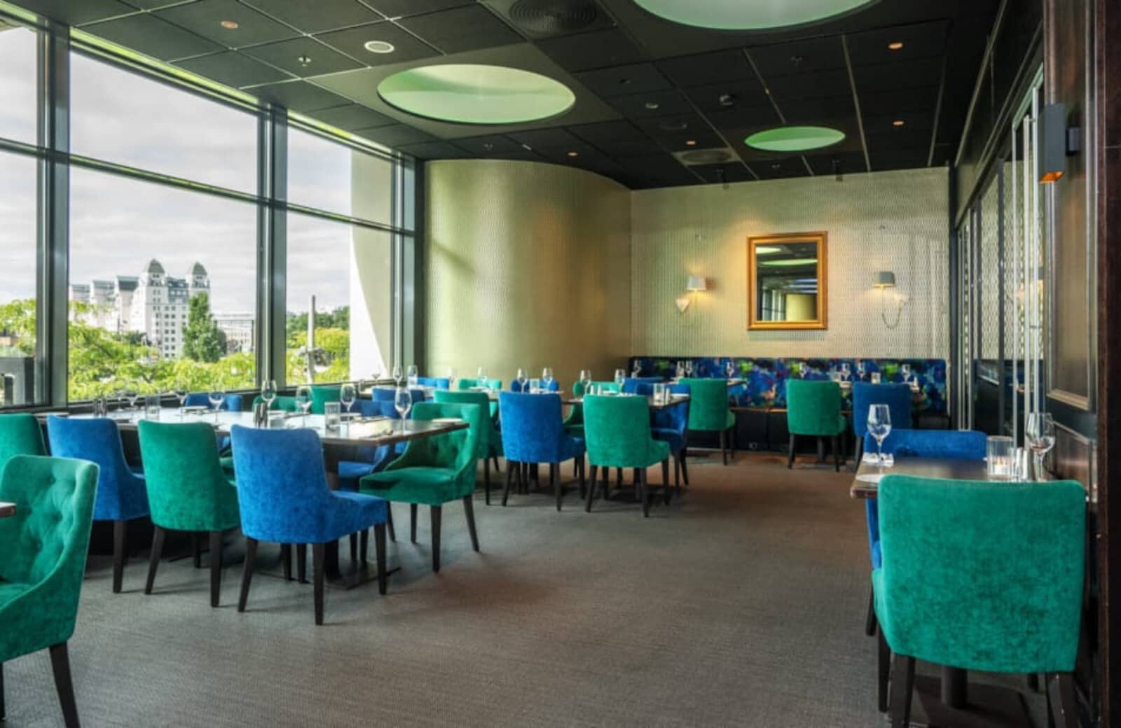 Dining room with floor-to-ceiling windows and city skyline views