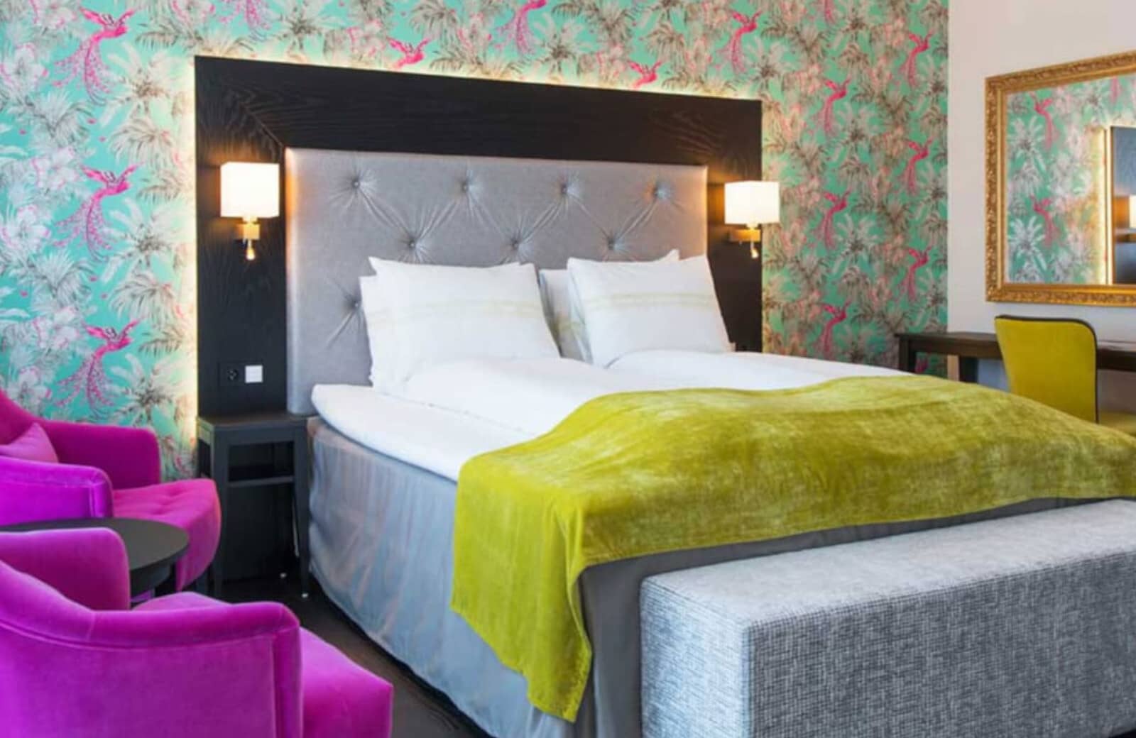 Guest bedroom with king bed, dedicated workspace, and velvet armchairs