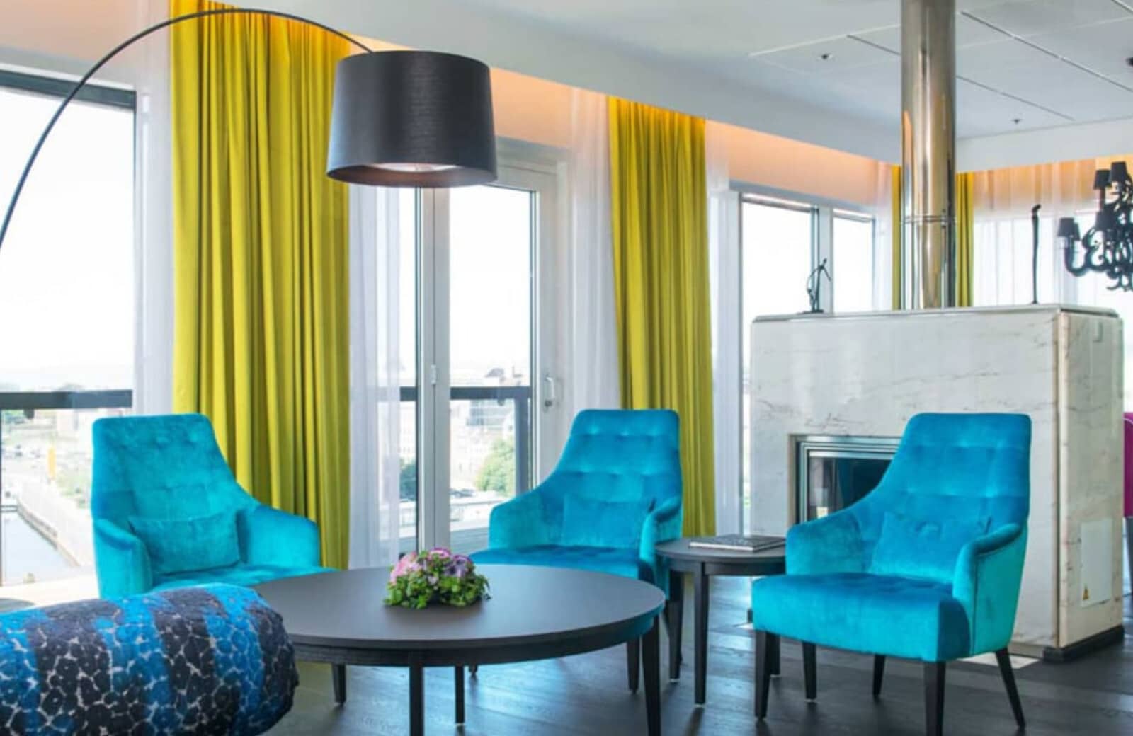 Seating area with wood-burning fireplace and floor-to-ceiling windows