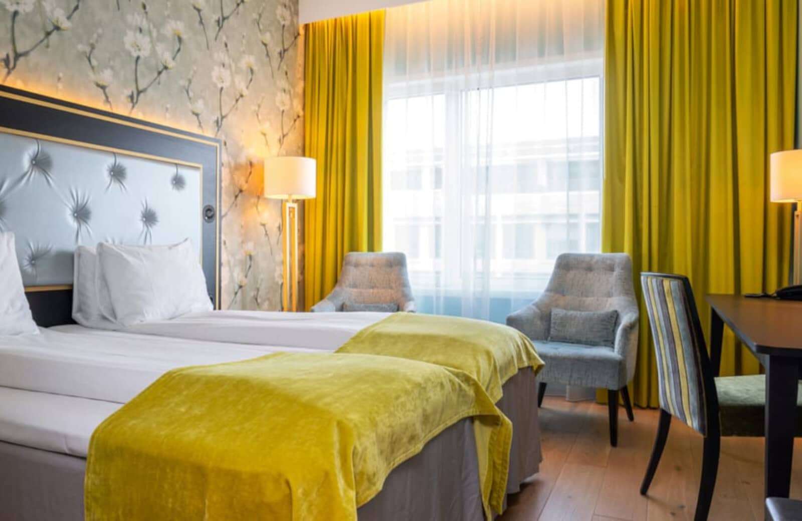 Guest bedroom with two twin beds and dedicated workspace desk