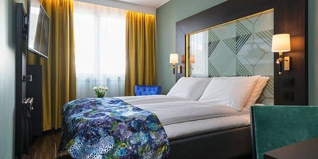 Guest bedroom with king bed and wall-mounted smart TV