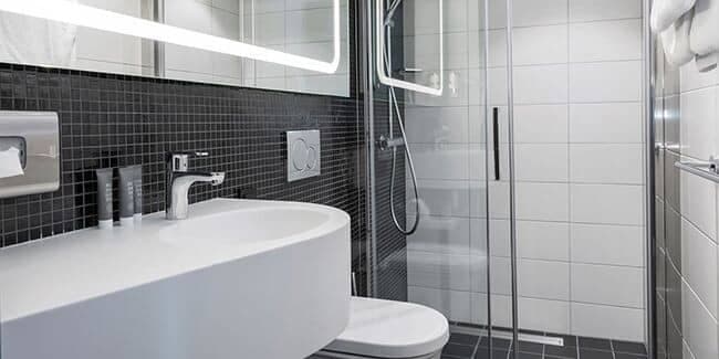 Bathroom with walk-in rainfall shower and LED backlit mirror