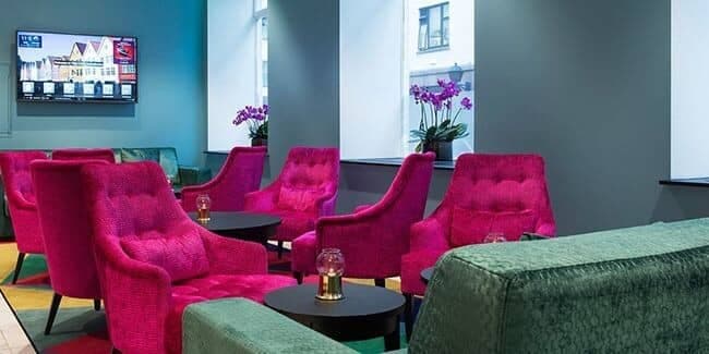 Shared lounge area with Smart TV and armchair seating for groups