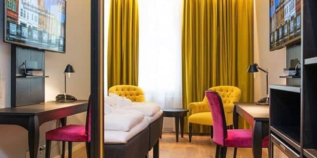 Guest bedroom with twin beds and dedicated desk workspace