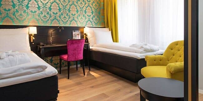 Guest bedroom with two twin beds and dedicated workspace desk