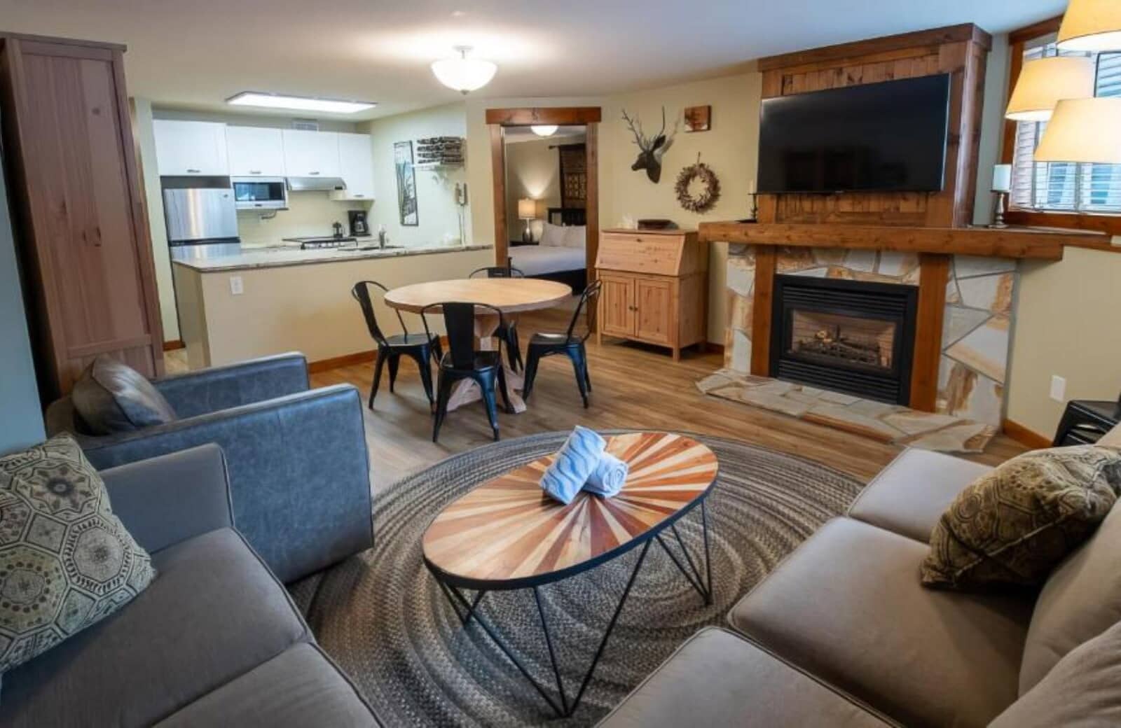 Open-plan living area with gas fireplace and 4-person dining table