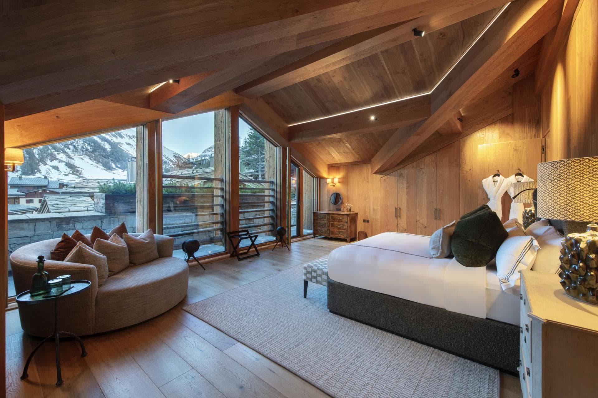 Primary bedroom with king bed, vaulted wood ceiling, and mountain views