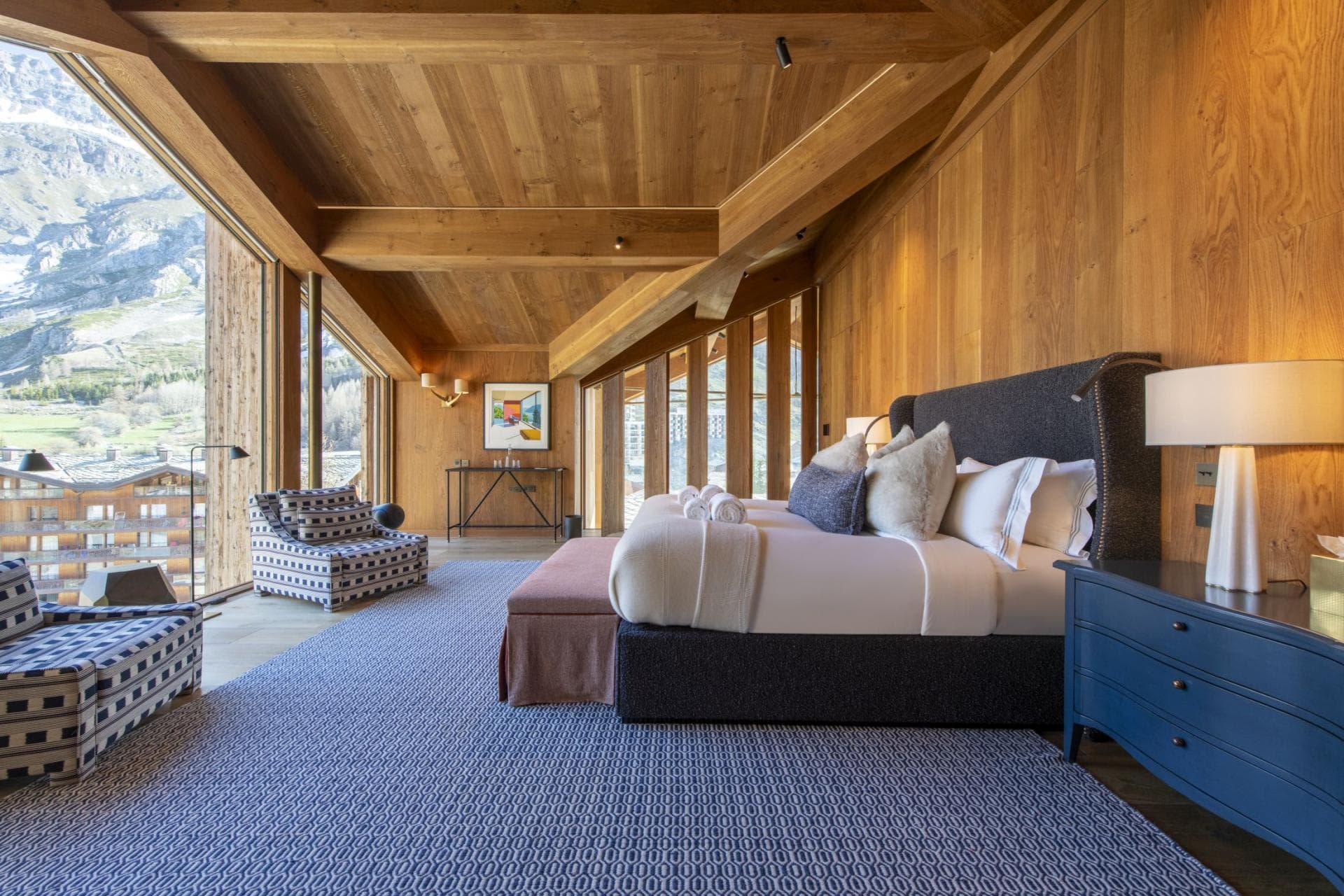 Primary bedroom with king bed, vaulted wood ceilings, and mountain views