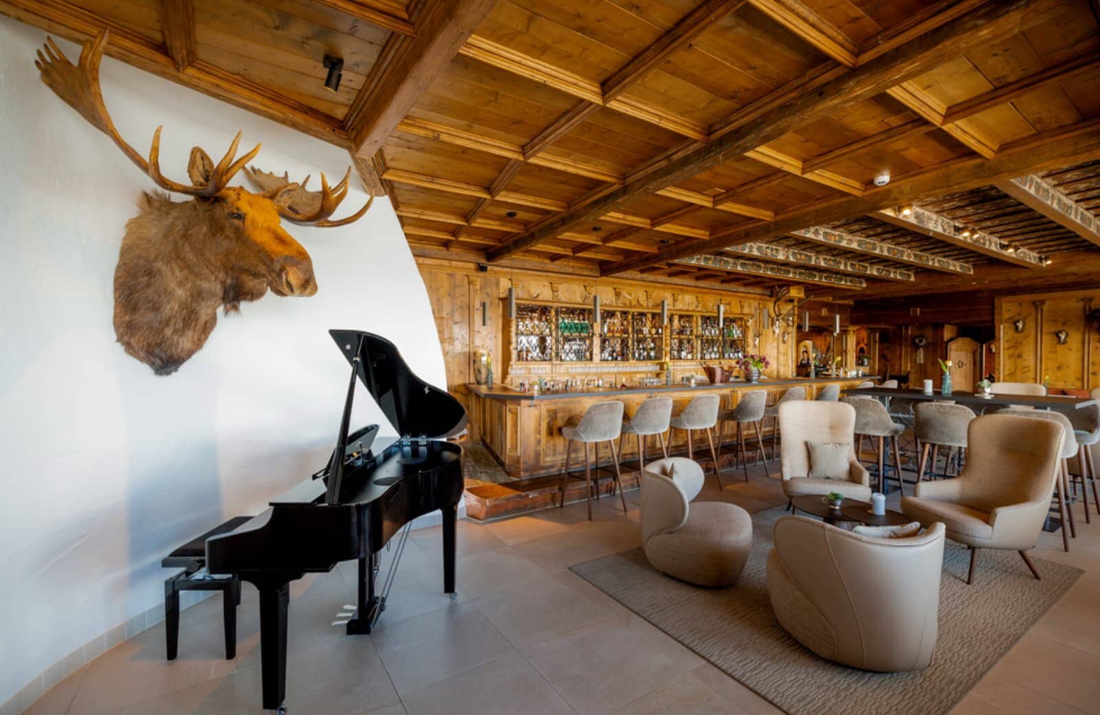 Lounge area with grand piano and full-service bar seating