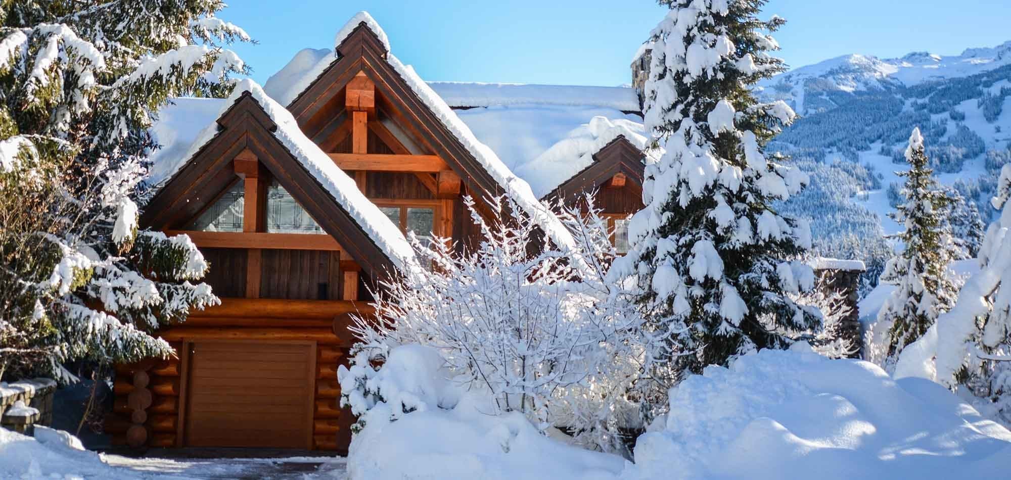 Log chalet exterior with private garage and ski-in/ski-out mountain access