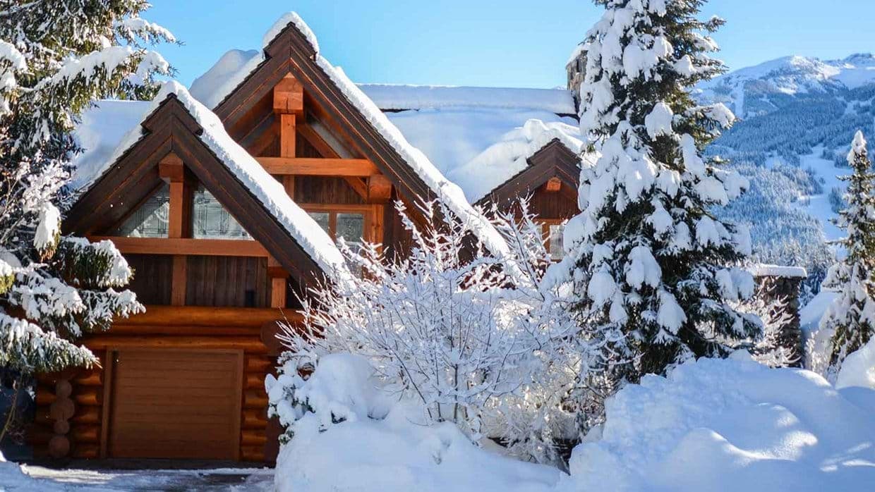 Log cabin exterior with private garage and ski-in/ski-out mountain access