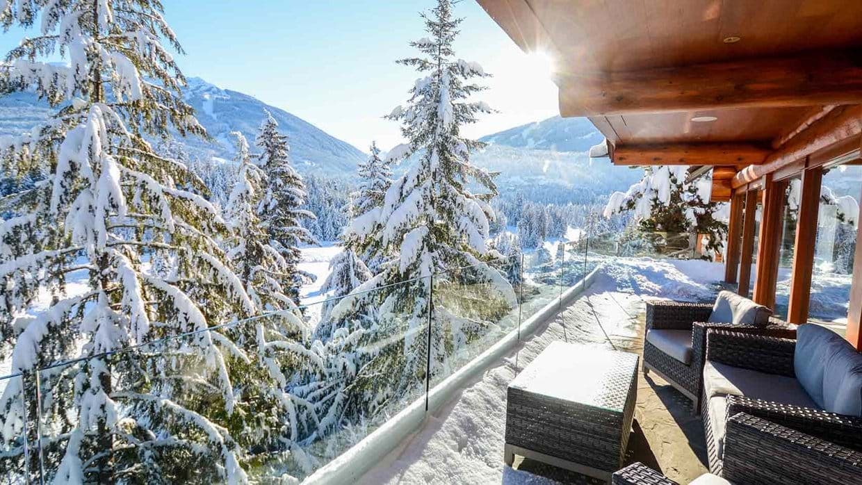 Covered balcony with glass railings and mountain views