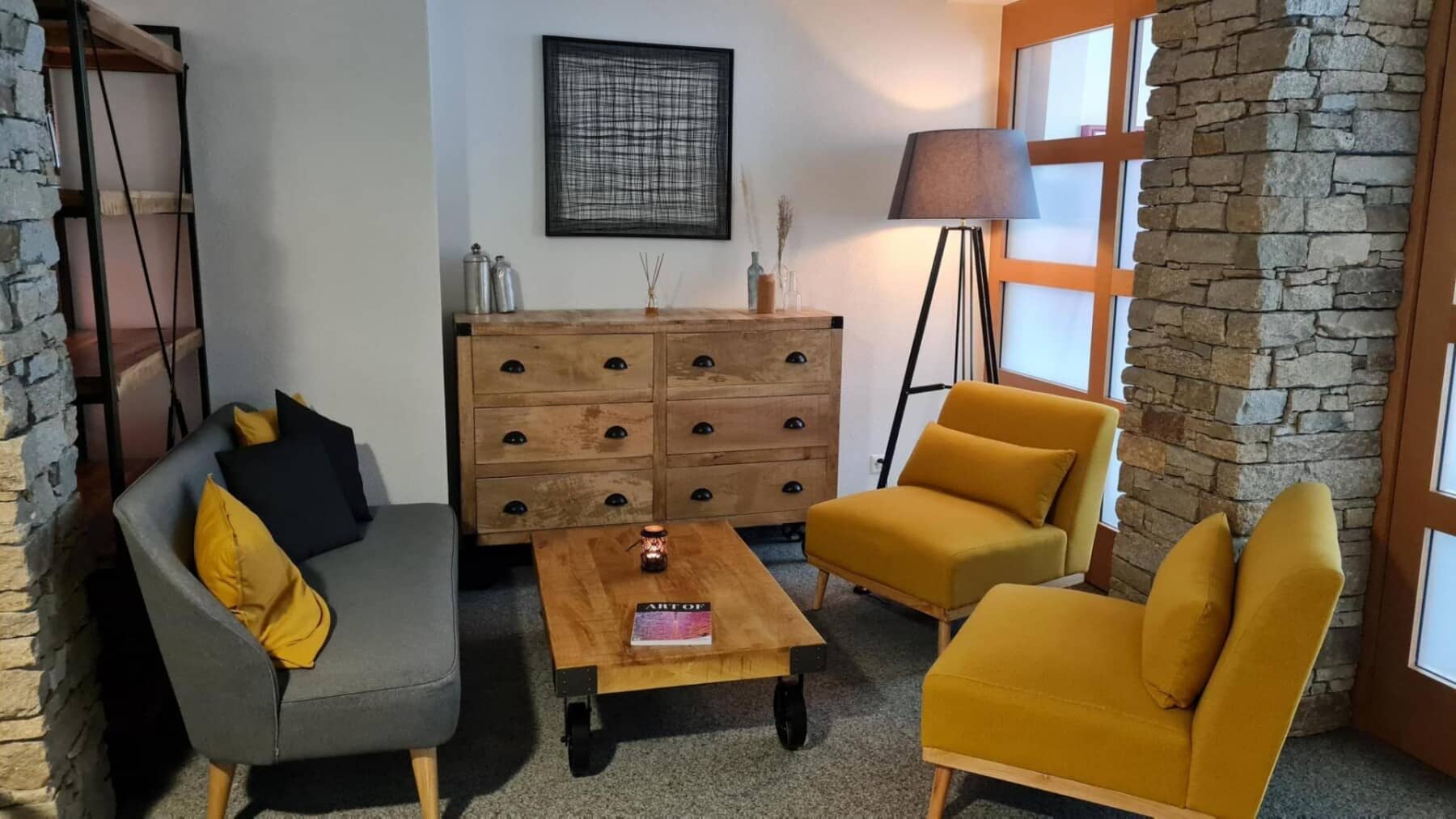 Sitting area with two armchairs, small sofa, and wood dresser storage