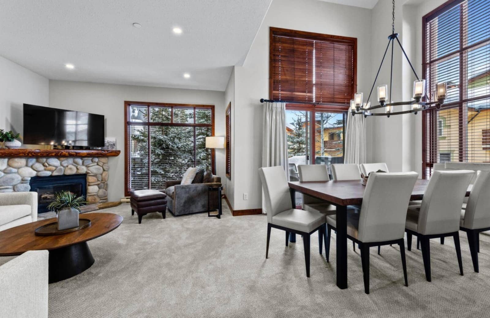 Open living and dining area with fireplace and seating for 8