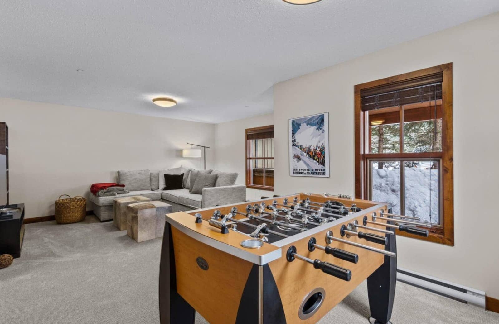 Lower-level game room with foosball table and sectional sofa