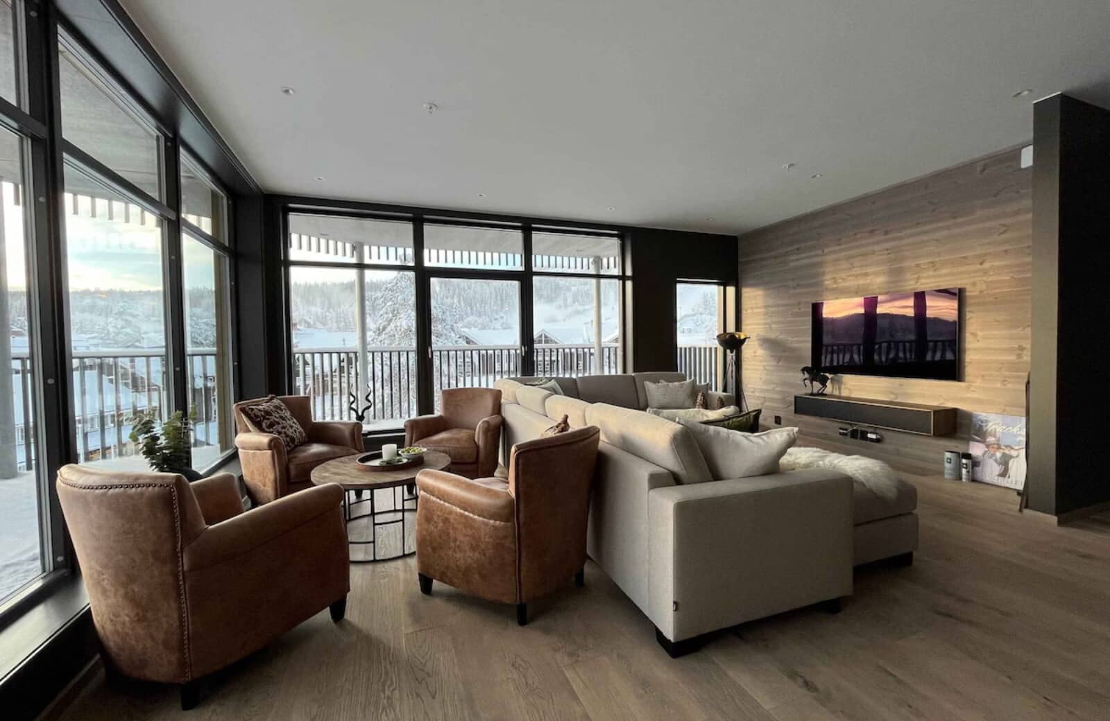Living area with floor-to-ceiling windows, seating for 10, and mountain views