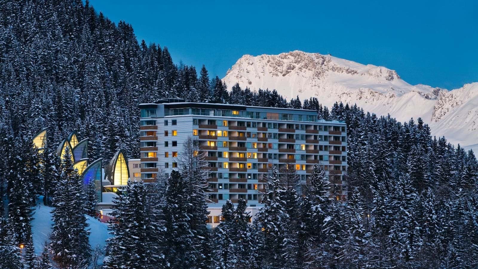 Ski-in/ski-out hotel exterior with mountain views and glass spa sails