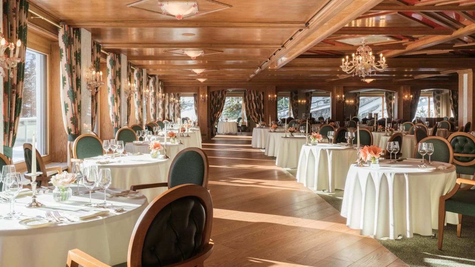 Formal dining room with wood-paneled ceilings and mountain views
